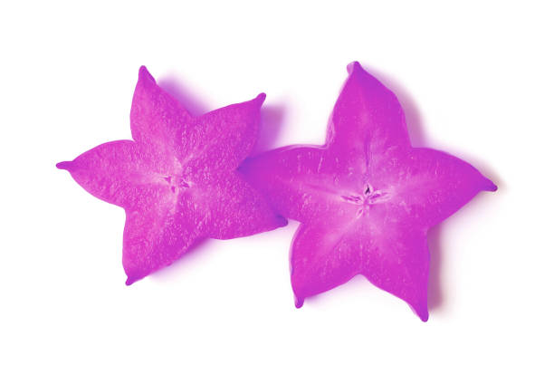 Pair of Sliced Ripe Fresh Star Fruit in Pop Art Styled Vibrant Purple on White Background