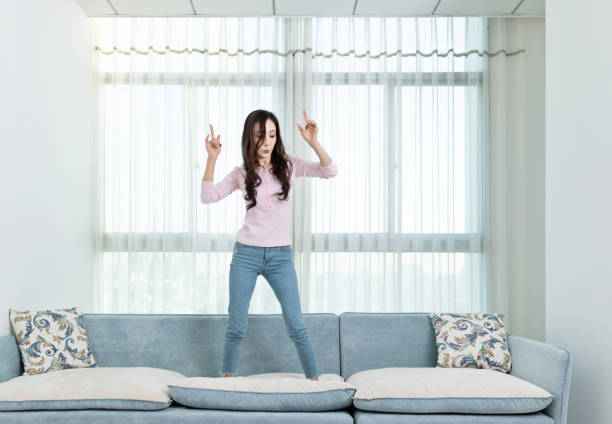 istock Woman dancing on the sofa 1157377559
