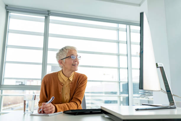 istock Happy business woman making notes 1157377564