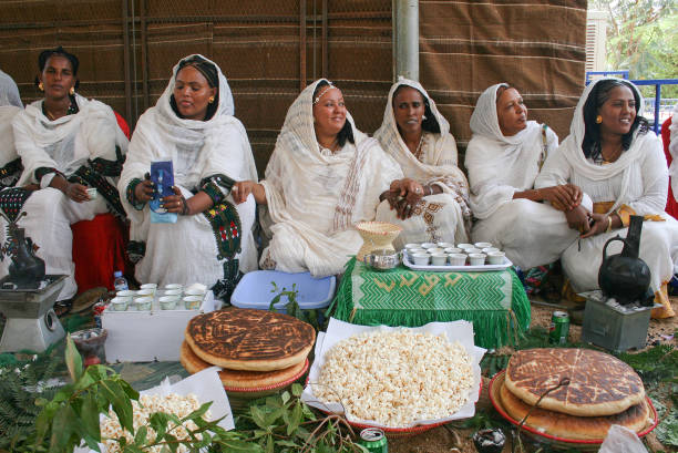 Ethiopian and Eritrean women celebrating the traditional coffee ceremony with popcorn in Khartoum, Sudan Khartoum, Sudan - March 10, 2011: Ethiopian and Eritrean women celebrating the traditional coffee ceremony with popcorn in Khartoum, the capital and largest city of Sudan, located at the confluence of the White Nile, flowing north from Lake Victoria in Uganda, and the Blue Nile, flowing west from Ethiopia. Khartoum is composed of 3 cities: Khartoum proper, Khartoum North and Omdurman. blue nile stock pictures, royalty-free photos & images