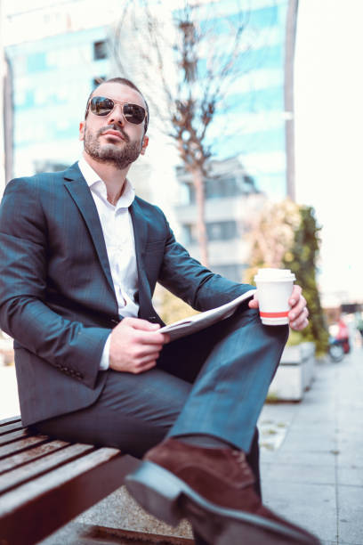 istock Handsome Businessman Taking A Pause From Work On Bench Outside 1157380273