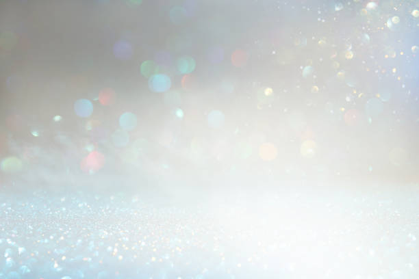 istock glitter vintage lights background. silver and white. de-focused 1157381925