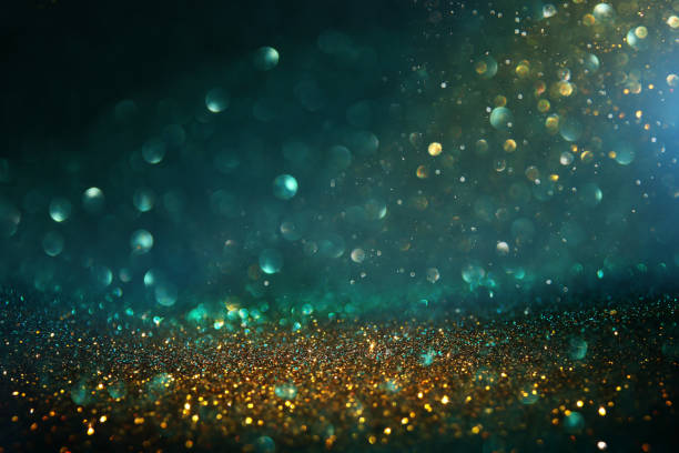 istock abstract glitter lights background. black, blue, gold and green. de-focused 1157381936
