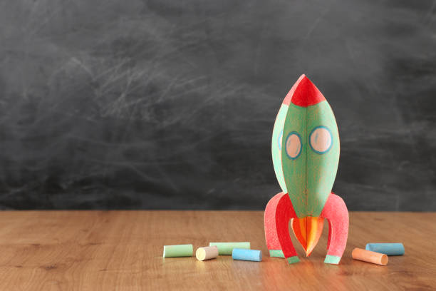 istock education and back to school concept. cardboard rocket and chalks in front of classroom blackboard 1157382094
