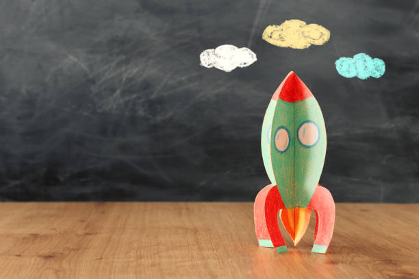 istock education and back to school concept. cardboard rocket in front of classroom blackboard 1157382095