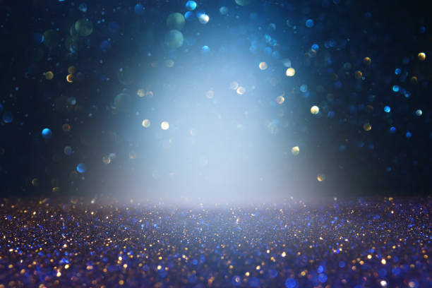 istock abstract glitter lights background. blue, gold and black. de focused. 1157382096