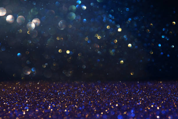 istock abstract glitter lights background. blue, gold and black. de focused. 1157382796