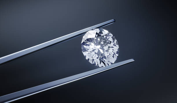 istock Single diamond in tweezers 1157383595
