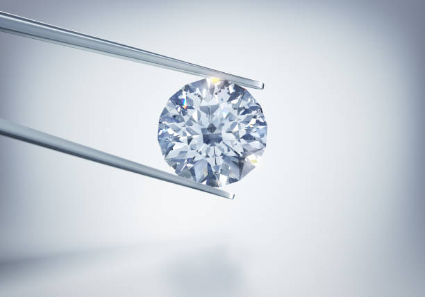 istock Single diamond in tweezers 1157383712