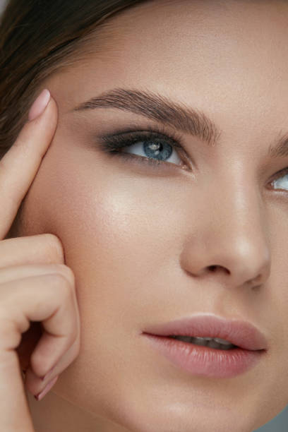 istock Beauty face makeup. Woman with beautiful eyes and eyebrows 1157386062