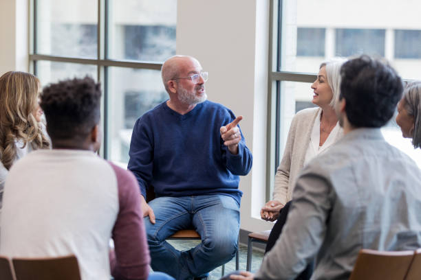 istock Mature husband points at mature wife during group therapy 1157387001