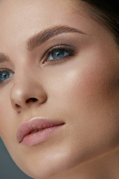 istock Beauty makeup. Woman face with eyes and eyebrows make-up 1157387119