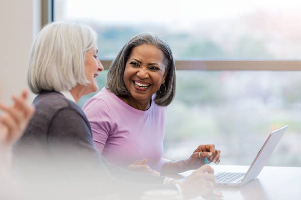 istock Taking a break from working on laptop two friends laugh 1157387165