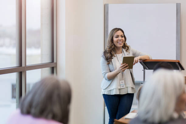 istock Cheerful mid adult teacher makes learning about digital tablets fun 1157387213