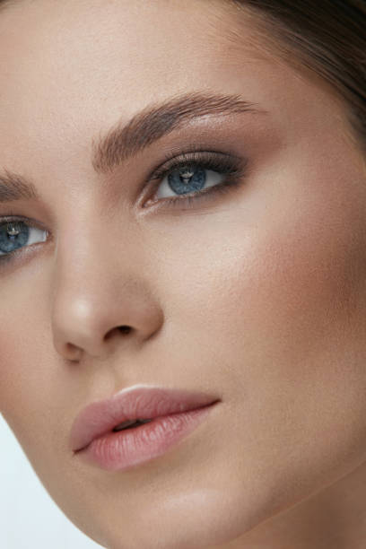 istock Beauty makeup. Woman face with eyes and eyebrows make-up 1157387658