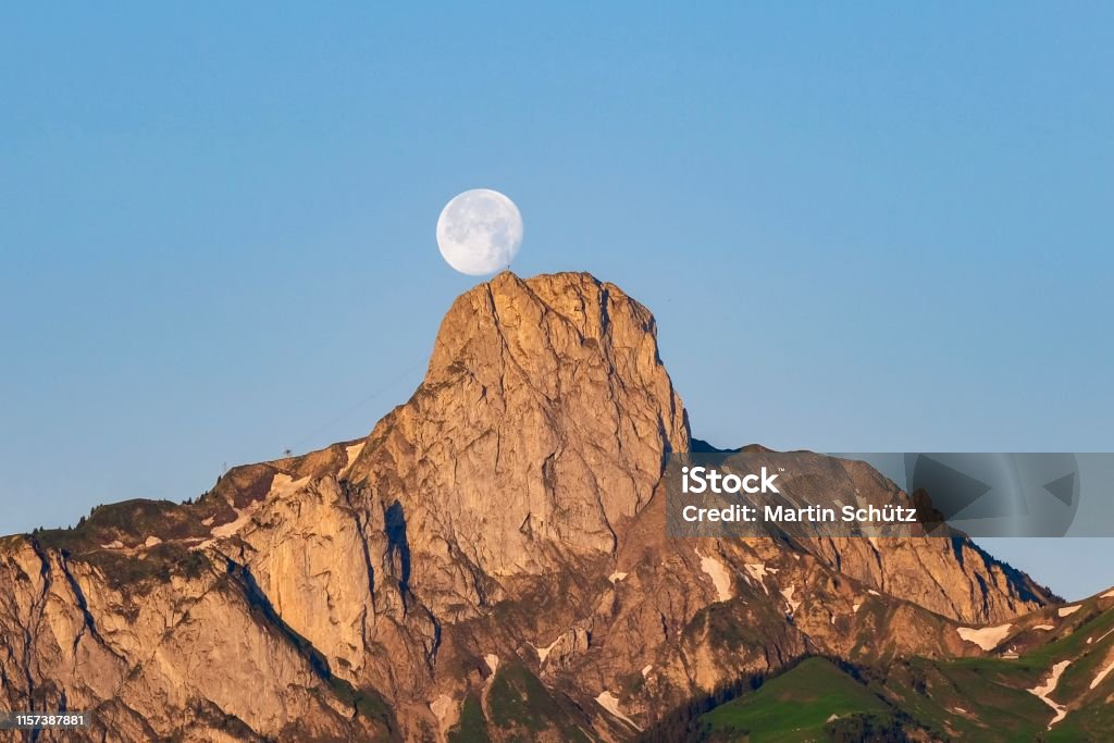 The full moon dances over the Stockhorn (mountain in Canton Bern, Switzerland) Beauty Stock Photo
