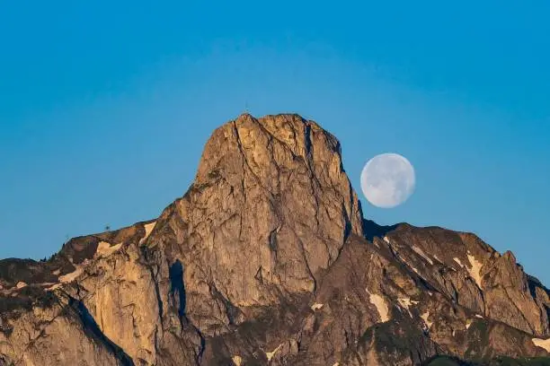 The full moon dances over the Stockhorn (mountain in Canton Bern, Switzerland)