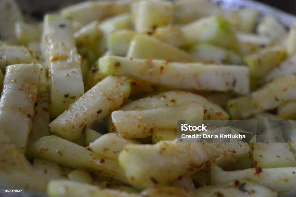 Homemade vegetable stew, cooked and sliced ​​zucchini and roasted on a metal pan with seasonings.  Healthy food, healthy products for human health. Delicious photos of food and food prepared at home.  Useful ingredients, home cooking with delicious and edible dishes. Kohlrabi Stock Photo