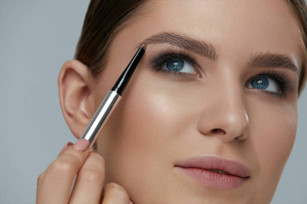 istock Eyebrow makeup. Beauty model shaping brows with brow pencil 1157390993