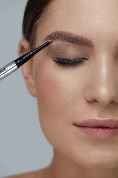 istock Eyebrow makeup. Beauty model shaping brows with brow pencil 1157391142