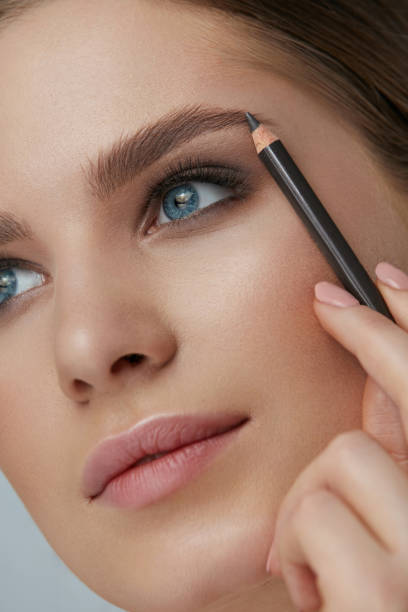 istock Eyebrow makeup. Beauty model shaping brows with brow pencil 1157391327