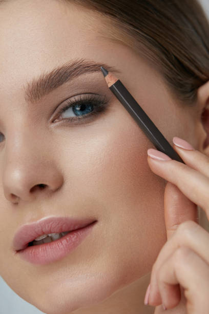 istock Eyebrow makeup. Beauty model shaping brows with brow pencil 1157391427