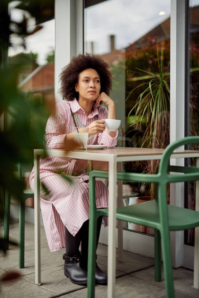 istock Woman drinking coffee in cafe. 1157398325