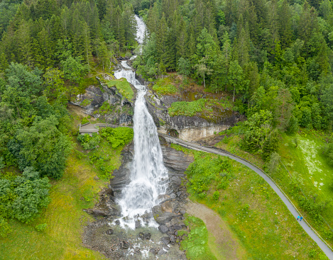 Aerial panorama of the famous Steinsdalsfossen where tourists can walk over a bridge behind the waterfall. Converted from RAW.