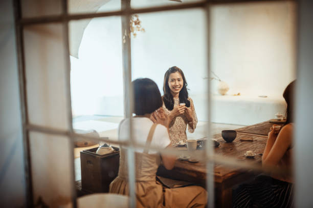 istock Chinese friends enjoying tea time - candid shot 1157401107