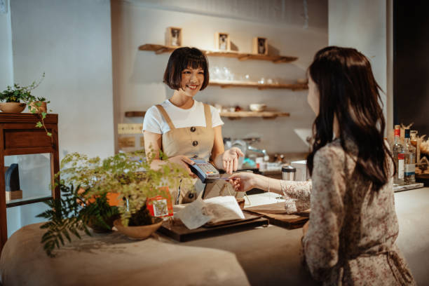istock Using contactless payment in shop in Asia 1157401485