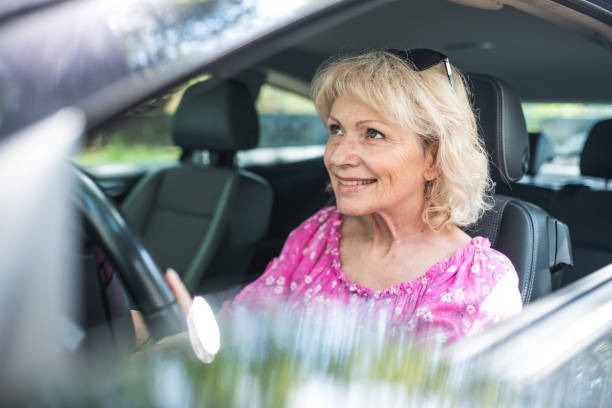 istock Senior woman driving in her car during summer 1157402913