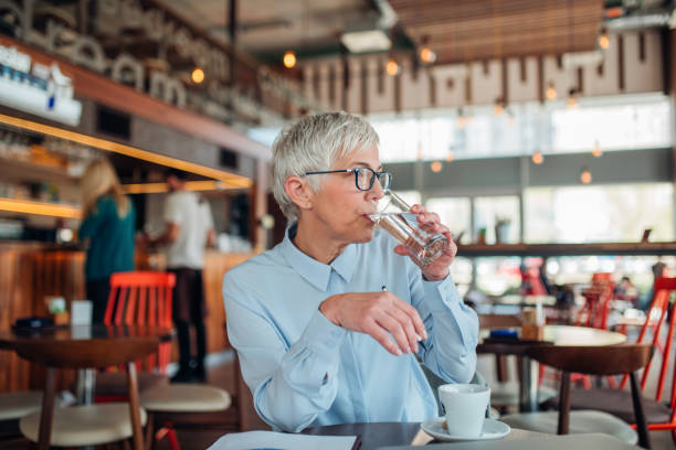 istock Older woman drinking water 1157404853