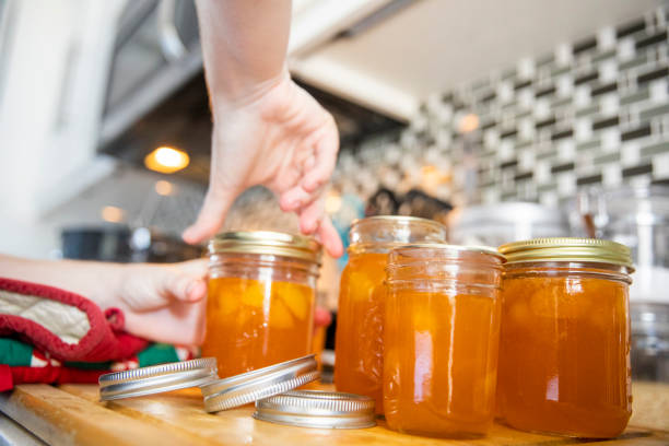 pouring jam in den jar - jar canning food preserves stock-fotos und bilder