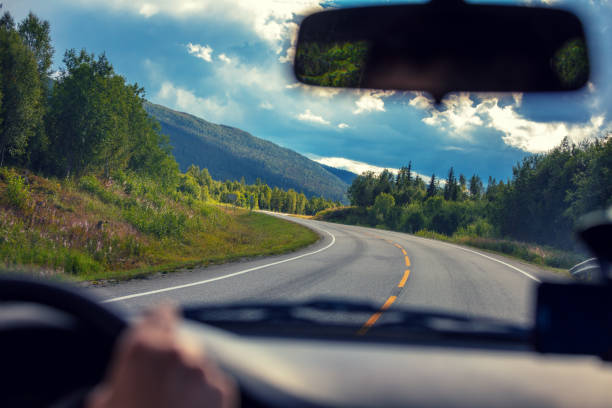 Driving a car on a mountain road. View from the windscreen of beautiful nature of Norway stock photo