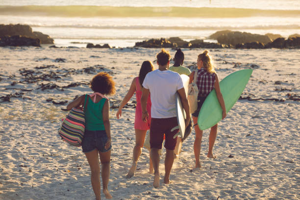 istock Group of friends walking towards the beach 1157414012