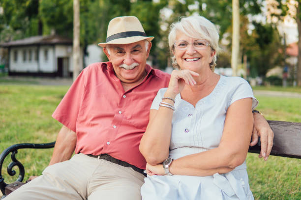 istock Senior couple sitting on a bench 1157414130