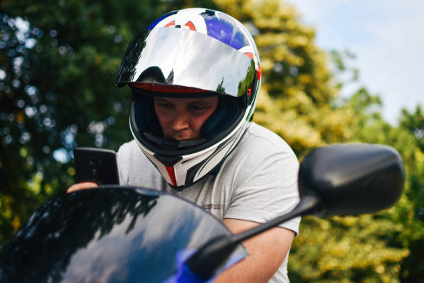 istock Motorcyclist Adjusting the Navigation on Mobile Phone 1157421150