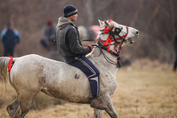 Pietrosani, Romania - January 6, 2019: Man is bareback riding an adorned horse before an Epiphany celebration horse race.