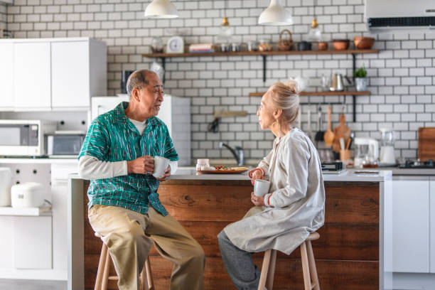 istock Senior Japanese Couple Enjoying Breakfast at Kitchen Counter 1157424561