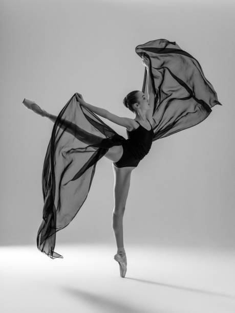 istock Young beautiful dancer dancing on gray background 1157425781