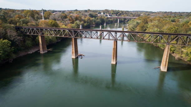 istock Scenic Daytime Aerial Landscape Photograph Side View Looking Down At Image Rusty Old Vintage Steel Railroad Train Track Trestle Crossing Historic Potomac River in Maryland, USA 1157426785
