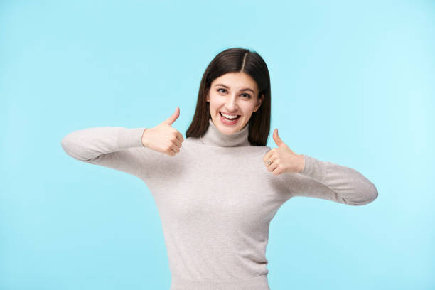 istock young caucasian woman showing thumps up 1157427031