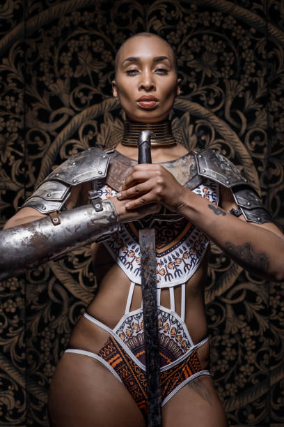 Beautiful black Sword wielding viking warrior female with a shaved head and weapons