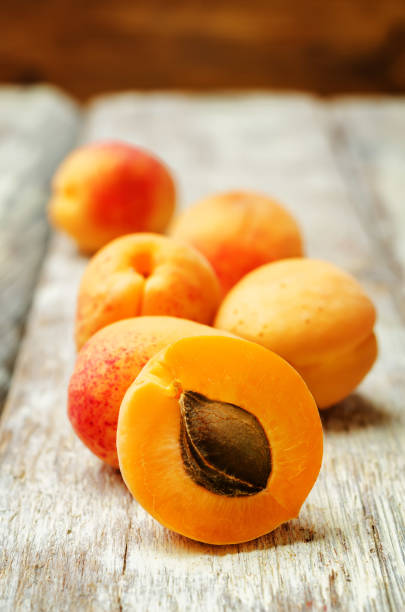 istock apricots with slices on a wooden background 1157429321