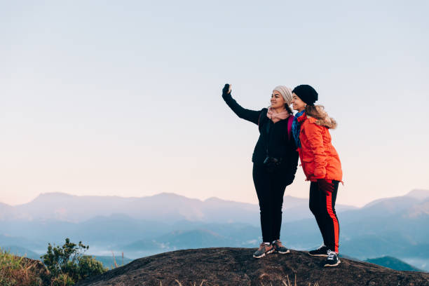 Two mid adult women taking a selfie outdoors at Serra dos Orgaos National Park Two mid adult women taking a selfie outdoors at Serra dos Orgaos National Park glengarry cap stock pictures, royalty-free photos & images