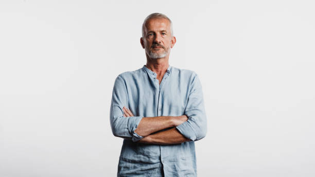 istock Senior man standing with arms crossed 1157431306