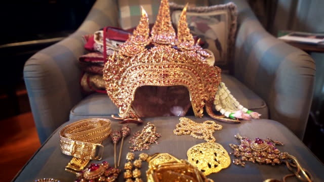 Dolly shot Camera of Ancient golden crown and accessories with gemstones of traditional Thai drama actress.
