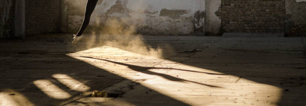 Silhouette of the ballerina dancing in an abandoned building.