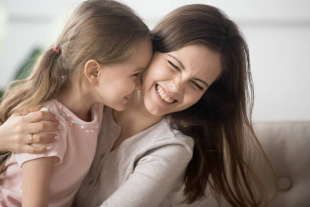 istock Laughing mother playing with daughter embrace her having fun together 1157439231