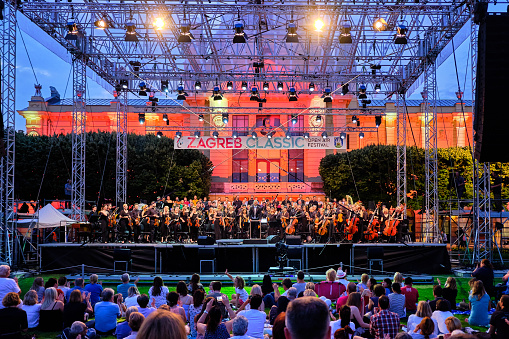 Zagreb, Croatia, June 21, 2019 : Open air Symphony Orchestra concert with large crowd in city park to celebrate summer, part of Zagreb Classic Open Air Festival